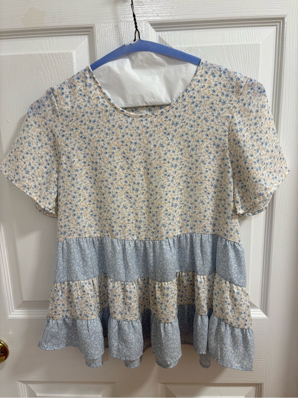 Paper Crane short-sleeve, tiered babydoll blouse featuring a mixed floral patter